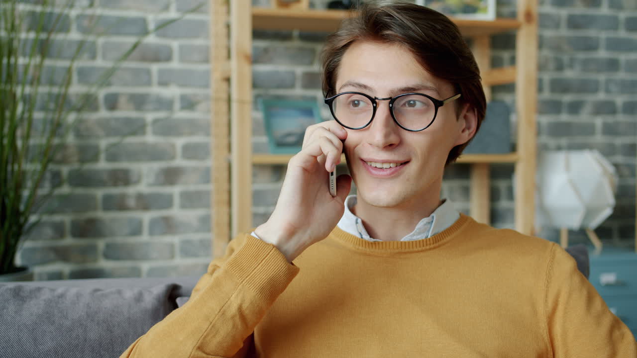 Young Man Talking on the Phone at Home