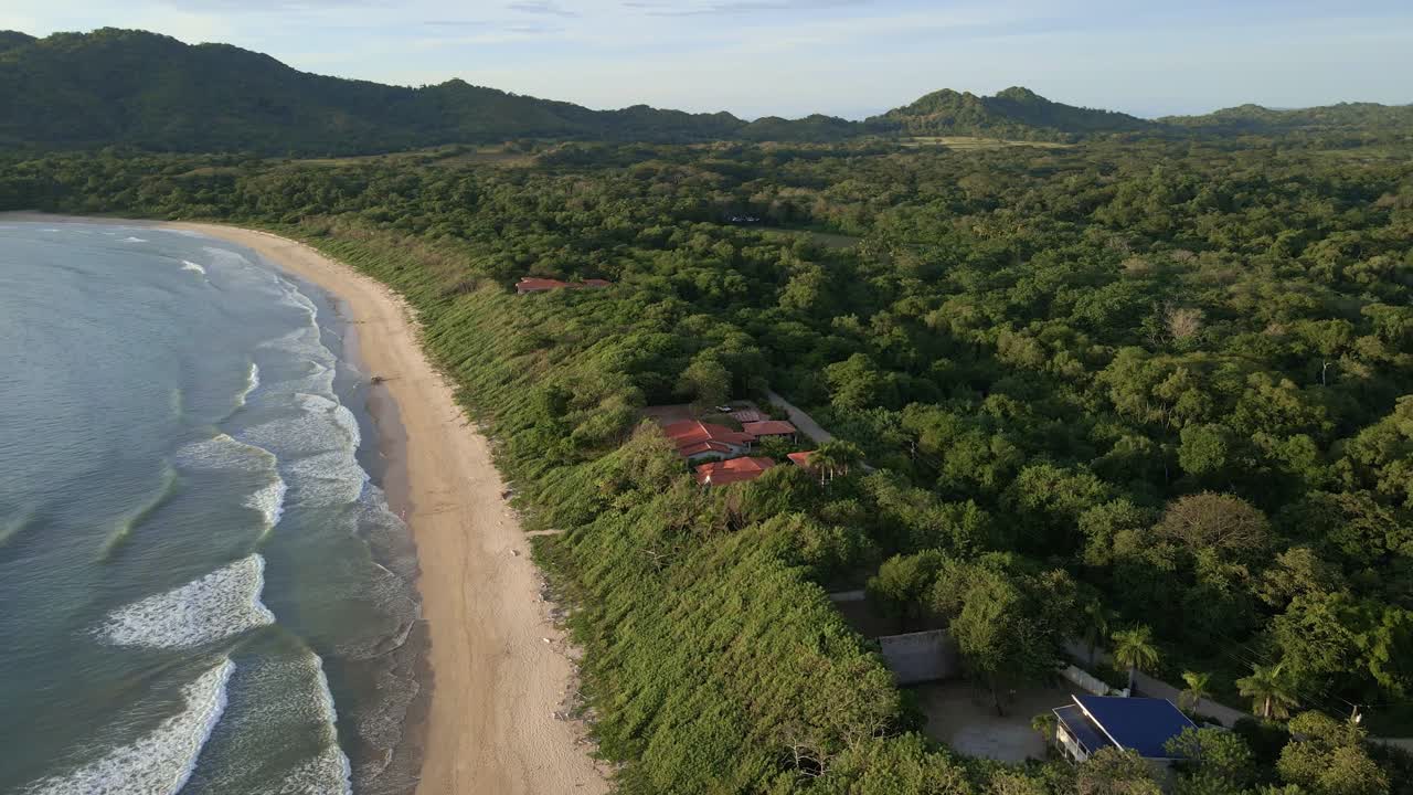 Long video of aerial orbit around beach front resort at Ventanas beach in Costa Rica