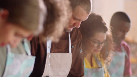 chef and students chopping garlic during cooking master class