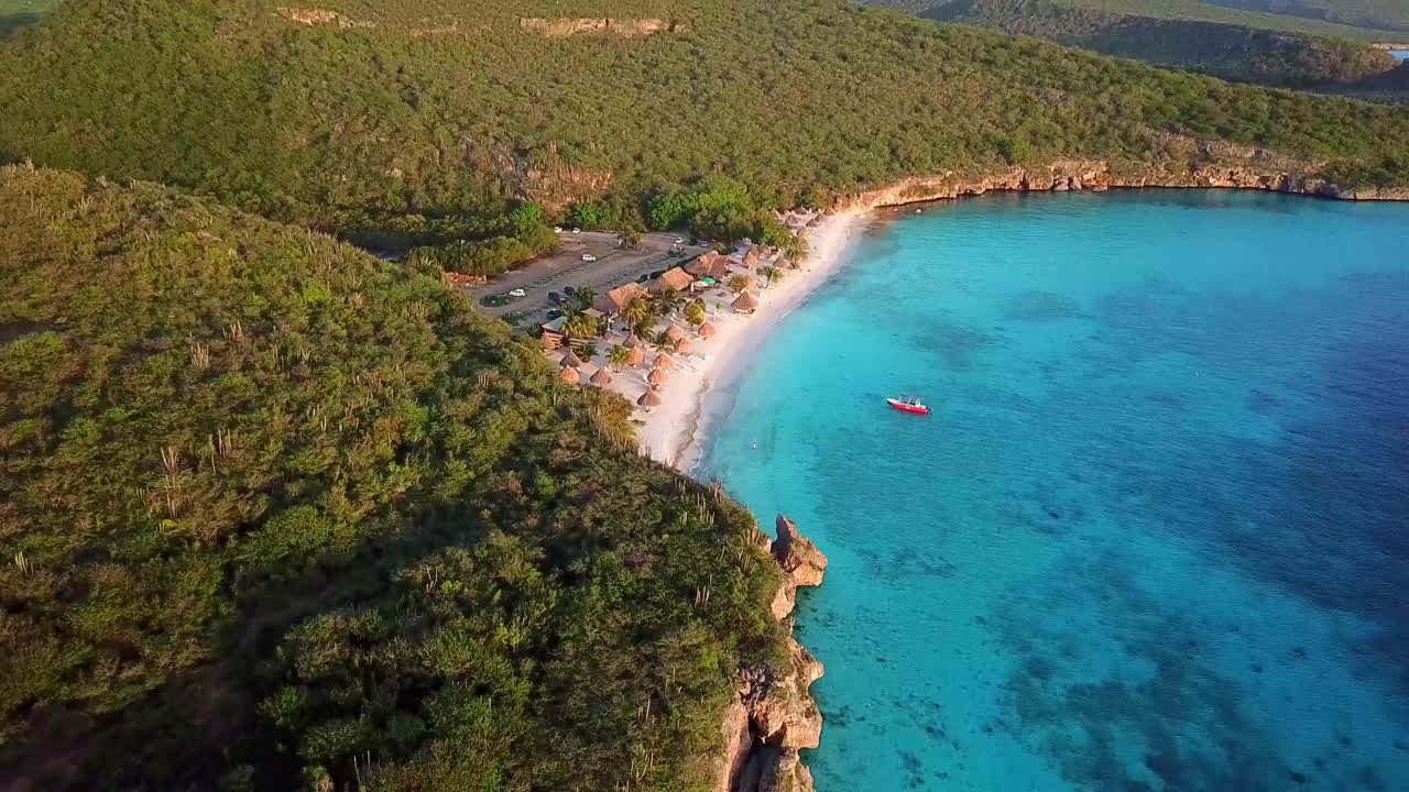 Tilt up aerial view of Cas Abao Beach on the Dutch Caribbean island of Curacao at sunset