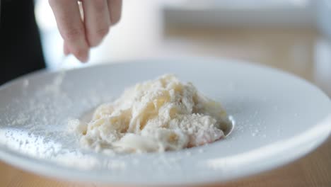 chef preparing creamy pasta dish