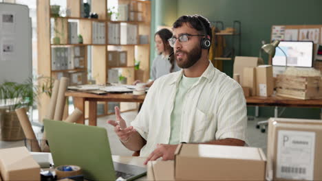 man with headset in office surrounded by boxes