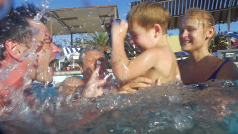 boy and his family having fun in the pool