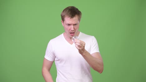 young handsome man playing with fidget spinner