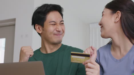 happy asian man and woman booking ticket online app from retail store.