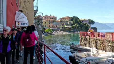 tourists walking by lake como in varenna