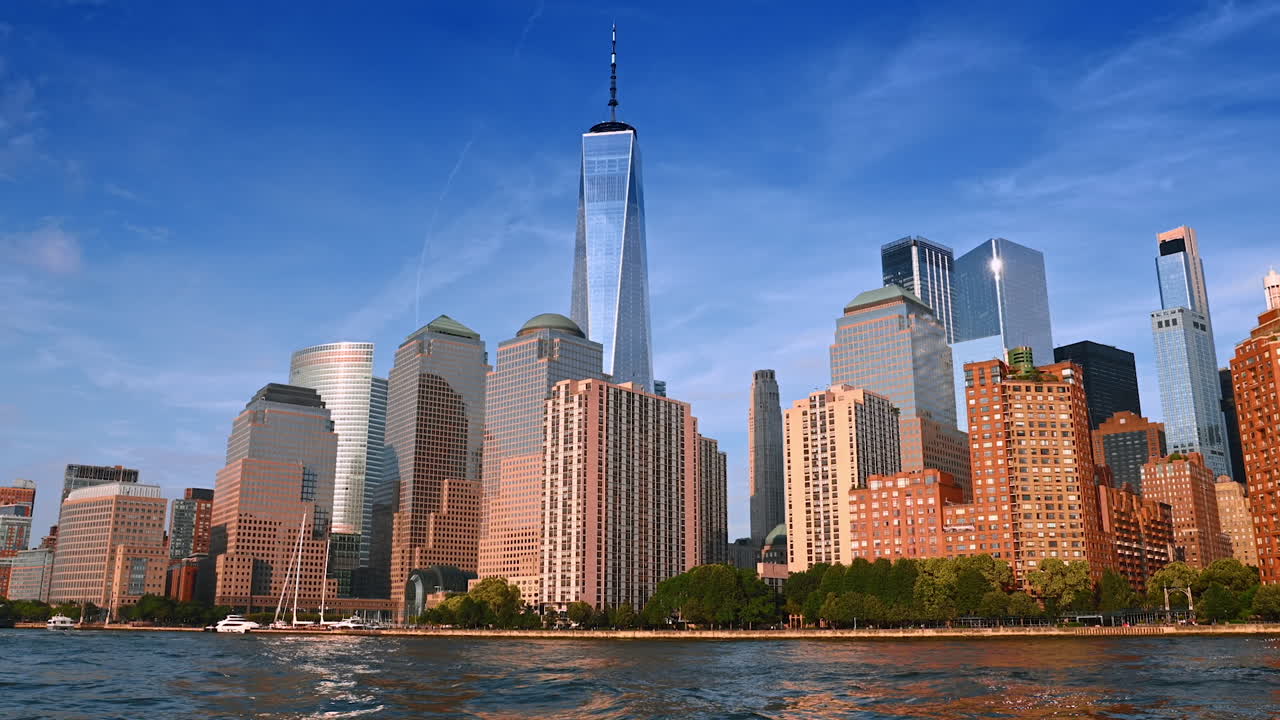 Gorgeous modern buildings reflecting sunshine. Low angle view at the Skyline of New York from riverscape