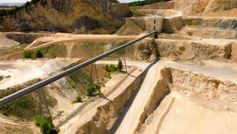 large quarry with stone sorting conveyor belt - aerial drone shot