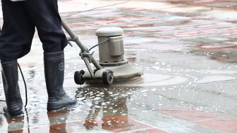 closeup shot of a man operating an industrial floor cleaning machine