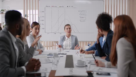 beautiful business woman team leader meeting with colleagues sharing creative ideas for startup project discussing corporate strategy in office boardroom