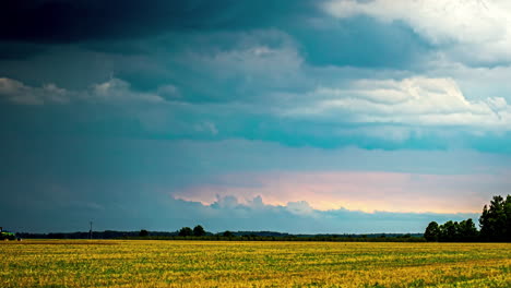a time lapse shot of a wind shear on a colourful sky and a field landscape