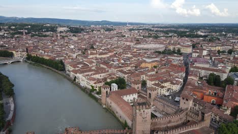 drone backward shot of verona city skyline - italy