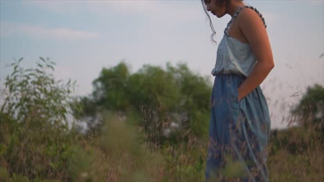 woman walking in the meadow on summer day