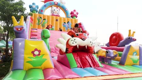 children playing on colorful inflatable slide