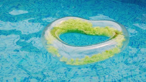 floating rubber heart in water pool of crystal clean water surface. the concept of summer holidays, discounts, fun and summer. high quality 4k footage.