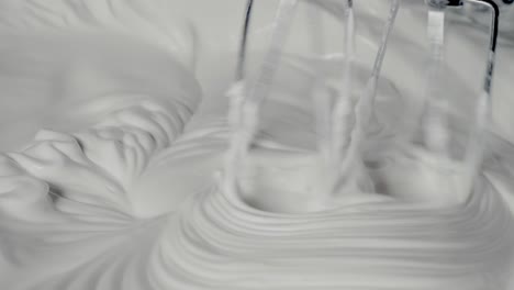 whisking egg whites into thick white foam