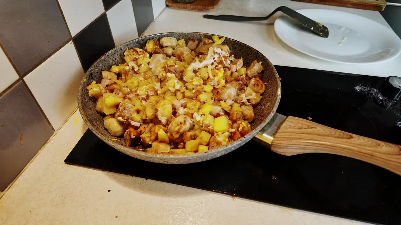Timelapse shows man cooking potatoes meat dumplings ham and mixing eggs