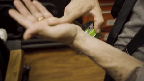 Man-With-Water-based-Firm-Hold-Hair-Pomade-At-The-Barber-Shop