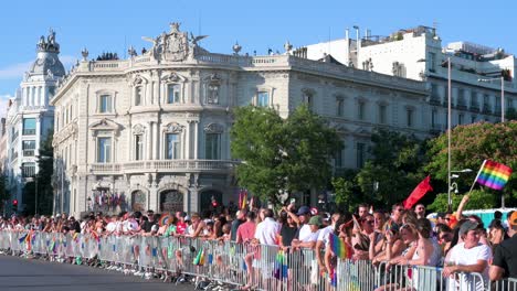 on the sidelines, people are seen behind fences as thousands of participants march through the streets during the lgbtqia pride month parade to stand against lgbti discrimination.