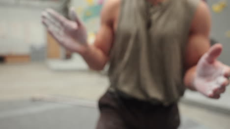 man clap his hands covered with climbing chalk (magnesium carbonate) - preparing to climb. - closeup shot