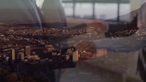 animation of businessman handshake over cityscape
