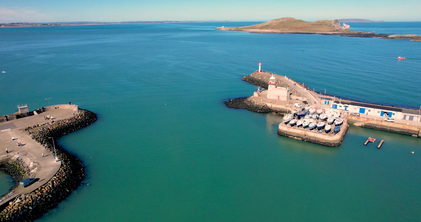 A 4K circular Drone shot of Howth Harbour Ireland's Eye and Portmarnock beach in the distancve