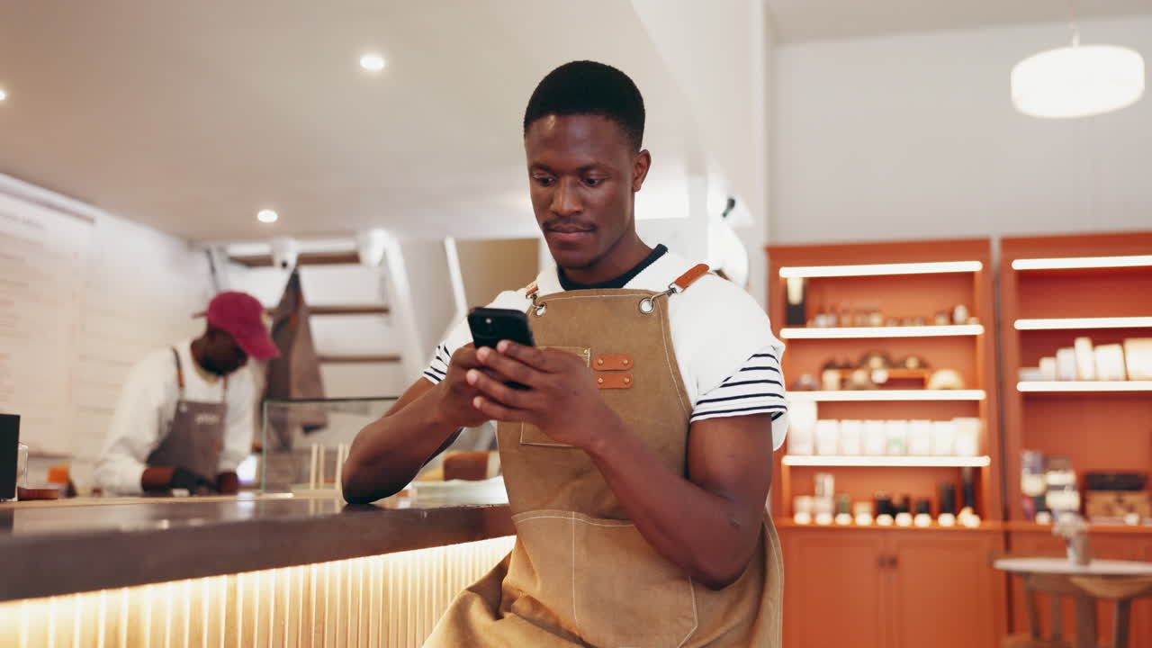 Man using phone in cafe