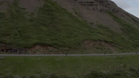 Motorcyclist-traveling-on-epic-mountainside-road-in-Icelandic-landscape