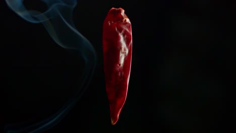 smoke moves past a red spicy chili