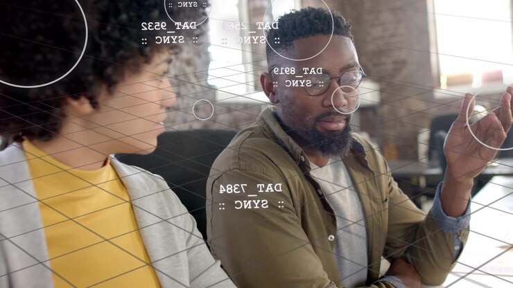 Man on sofa turning explaining tech data clarifying sync, AR grid showing DAT nodes on faces