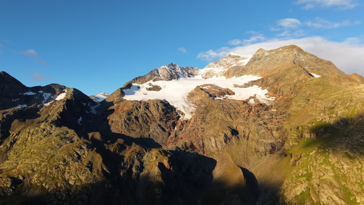 Sunny aerial view of Swiss Alps peaks and glaciers