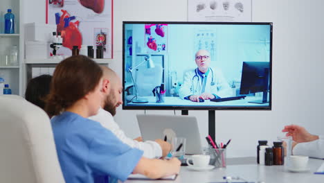 concentrated purposeful experienced medical team holding online video meeting