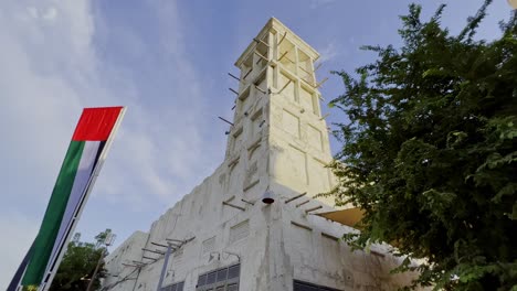 traditional arab wind tower on building roof in al fahidi historical district in dubai, uae