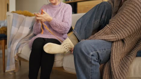 grandmothers knitting socks on sofa