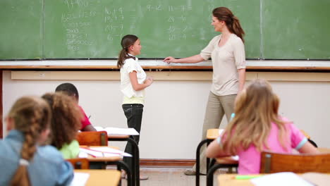 brunette girl writing on the chalkboard