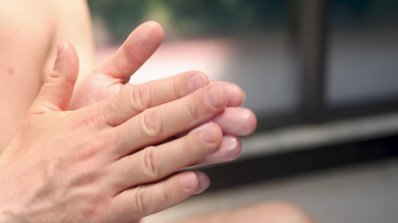 Man applies moisturizing white cream to hands 4k movie