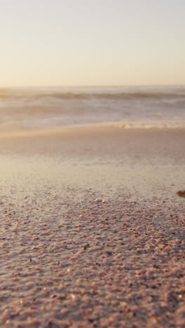 sunset and sea with waves and blue sky on empty sunny beach