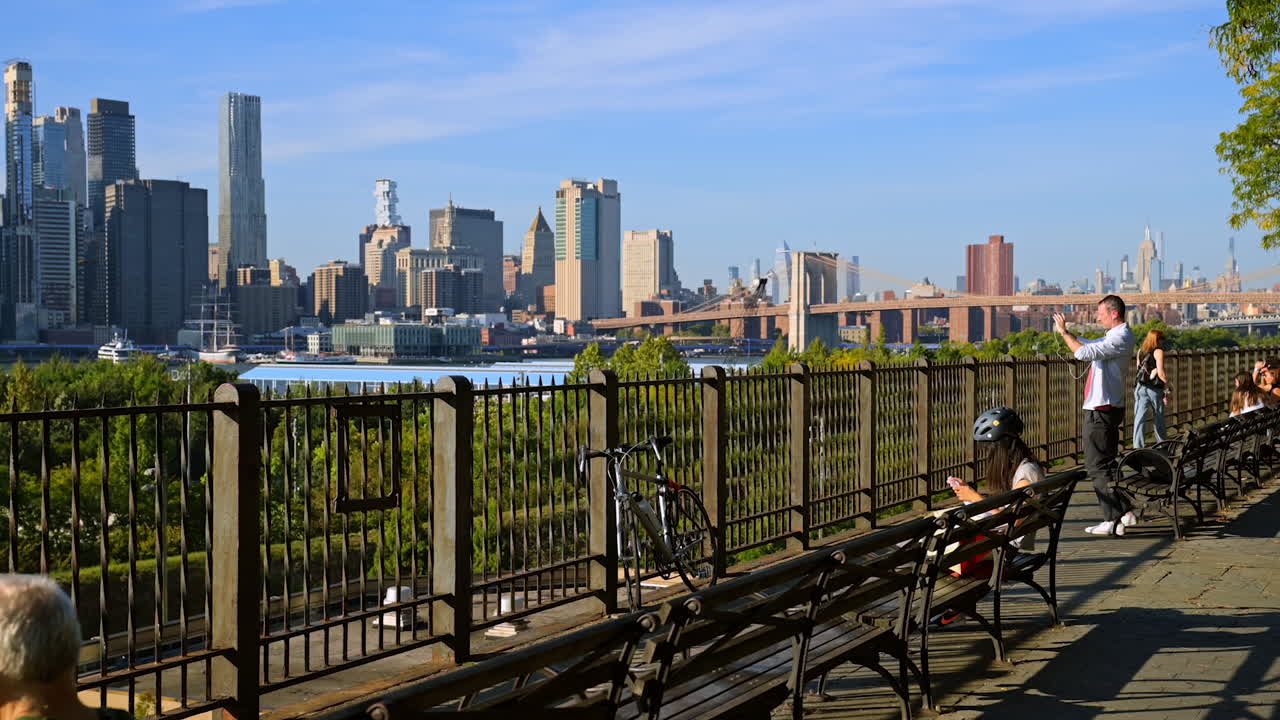 New York, USA, 9 August 2025: Brooklyn Heights Promenade with Manhattan skyline view. People relax and enjoy views of the Manhattan skyline and Brooklyn Bridge from Brooklyn Heights Promenade