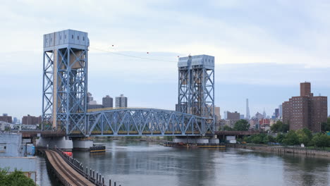 Crisp-cinematic-show-ground-steadycam-shot-of-the-Park-Avenue-Bridge-to-a-public-housing-project-with-Midtown-Manhattan-and-the-Empire-State-Building-in-the-far-distance