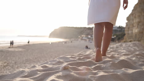 unrecognizable woman running in the summer sunset along the sunny exotic shore in portugal. slow motion, close-up