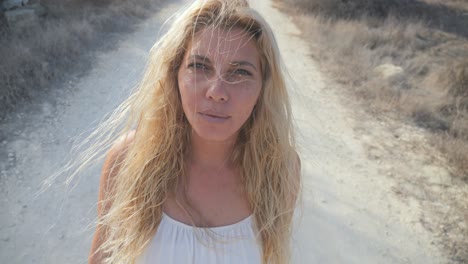 portrait of a woman in a white dress as she screams to the camera