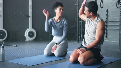 couple doing yoga in the gym