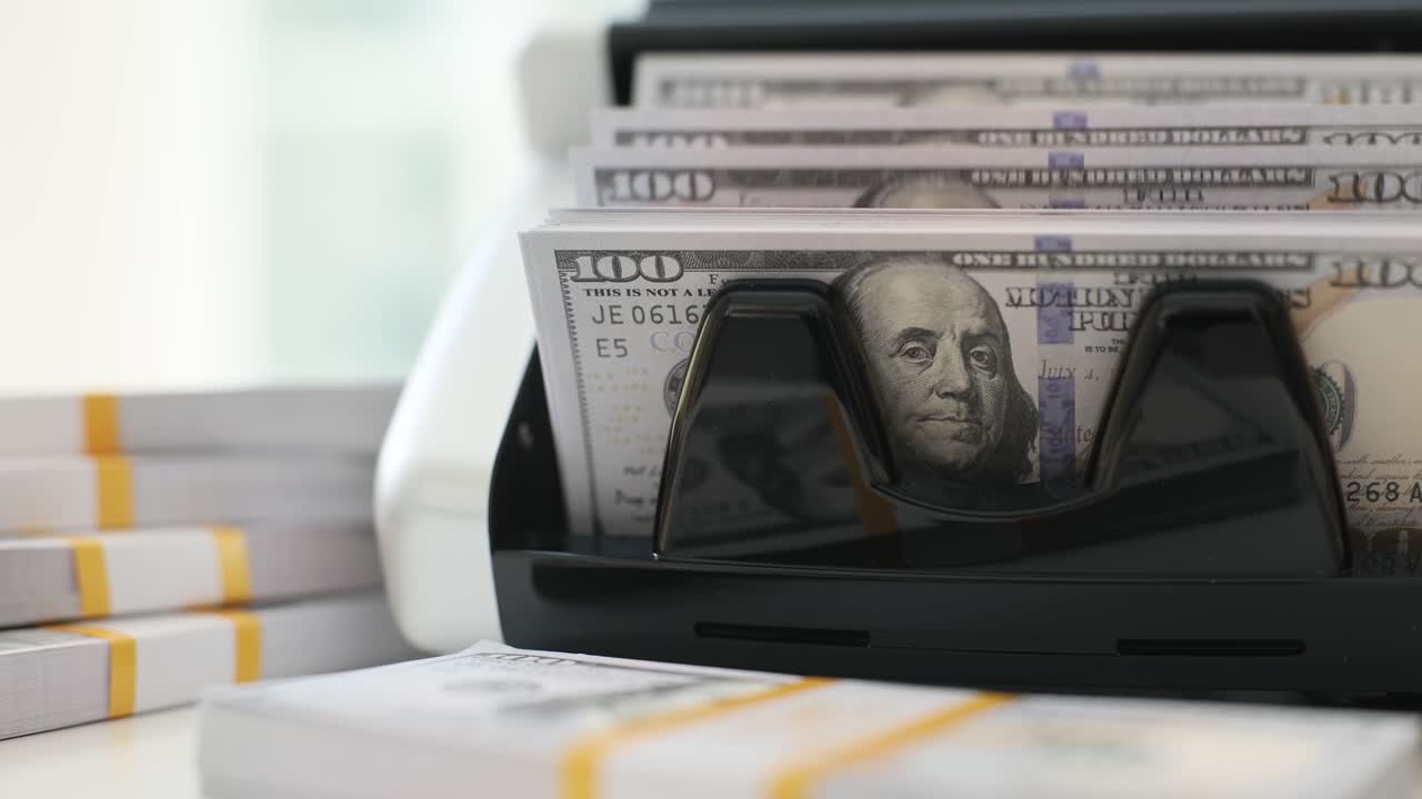 Money Counting Machine with Stacks of Hundred Dollar Bills