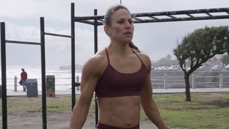 sporty caucasian woman exercising in an outdoor gym during daytime