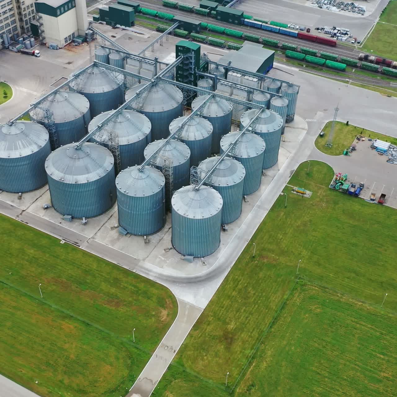 Steel grain silos elevators storage. Agriculture industry. Granary for keeping agricultural products. Manufacturing plant in nature. Aerial view.