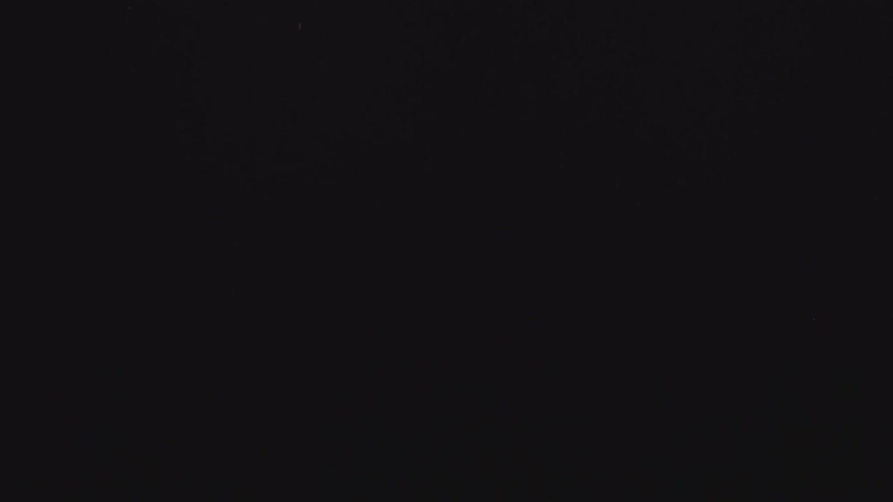 4k resolution of burning firework bright sparks on black background, Christmas and New year spirit. In and out of focus