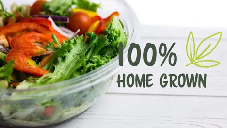 Animation-of-100-percent-home-grown-text-in-green-over-bowl-of-fresh-salad-on-white-boards