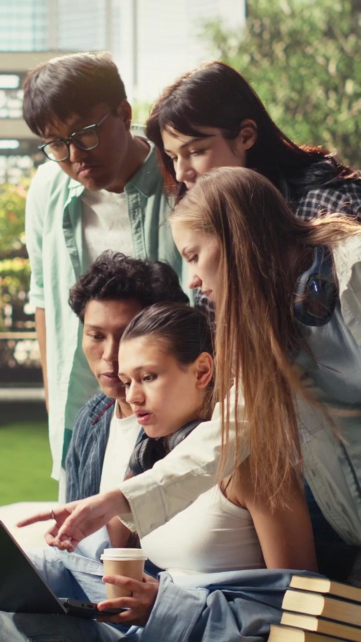 Vertical Video Classmates sitting on campus benches for quiet study with laptop and books,