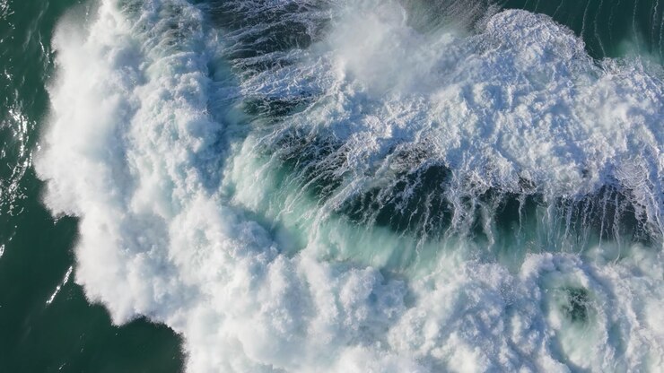 Aerial View Of A Powerful Ocean Wave With White Foam.