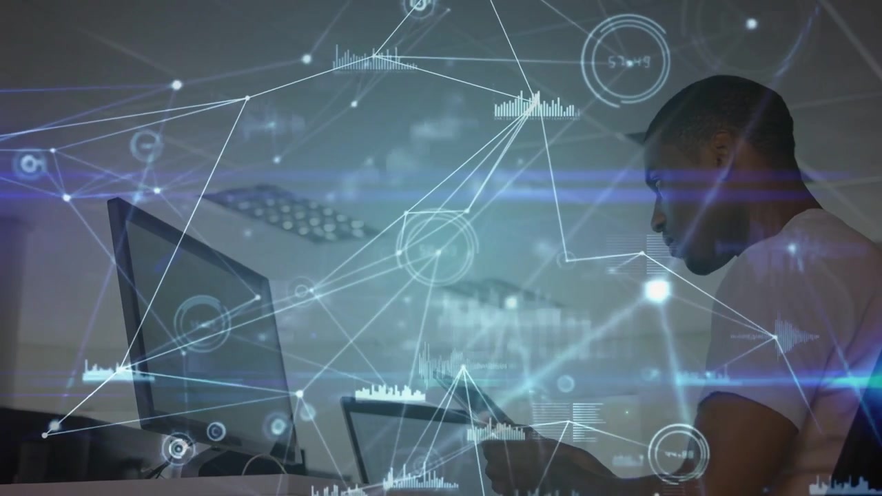 Man tapping handheld and scrolling at desk, initiating growing data overlays for monitoring charts